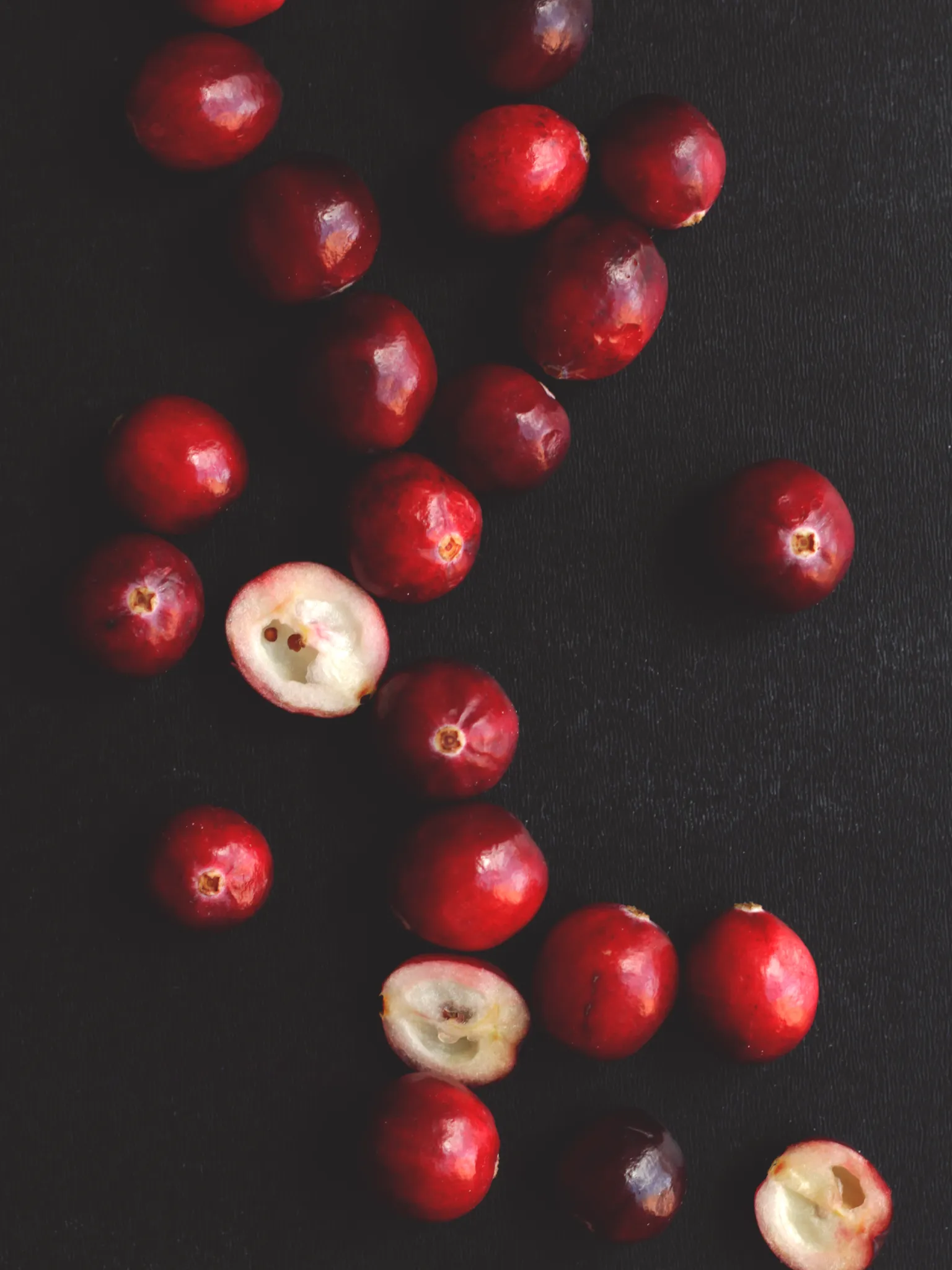 Fresh cranberries on a black background