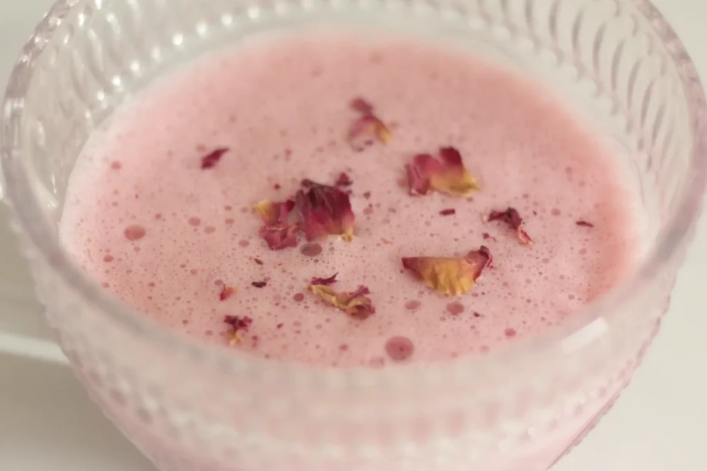 Close up of rose milk in a clear glass