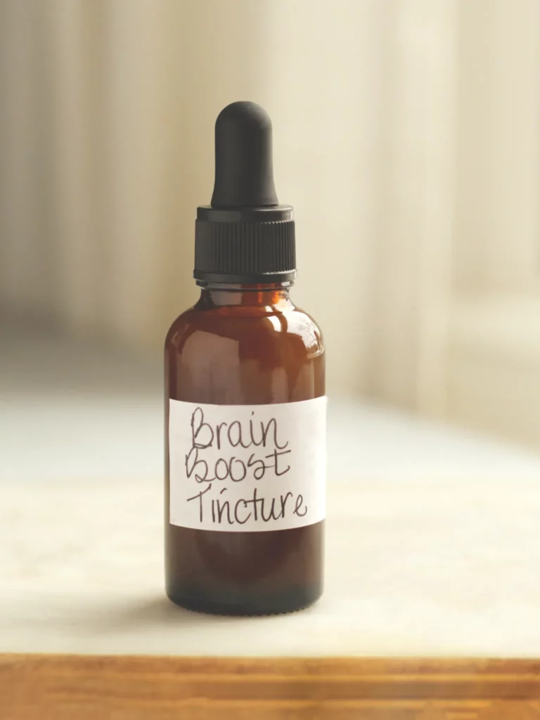 An amber bottle with dropper labeled 'Brain Booster Tincture'